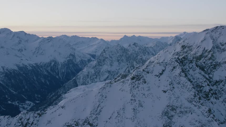 Snow covered mountain range at dusk