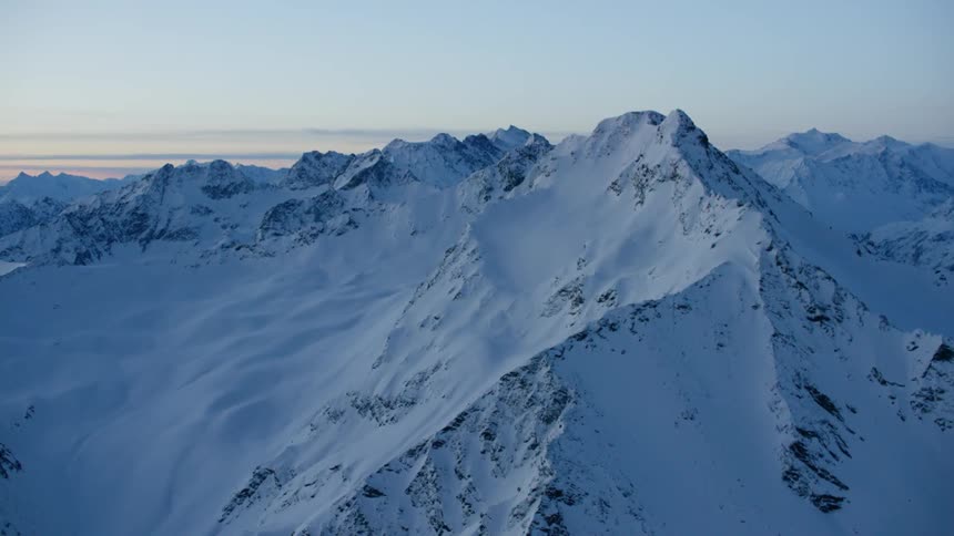 Snow covered mountain range at dusk