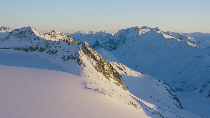 Snow covers rocky mountains