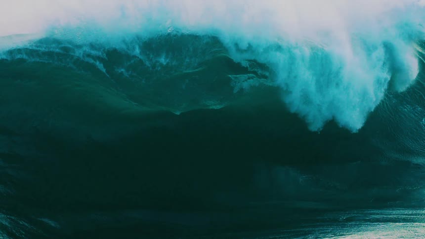 An epic and powerful ocean wave rises and crashes in a spectacular display of nature's force in super slow motion