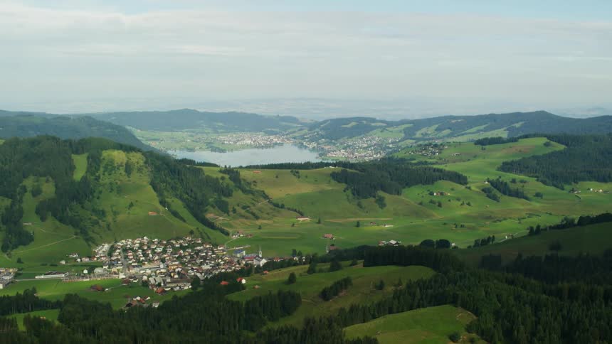 A small mountain town is shown near a lake