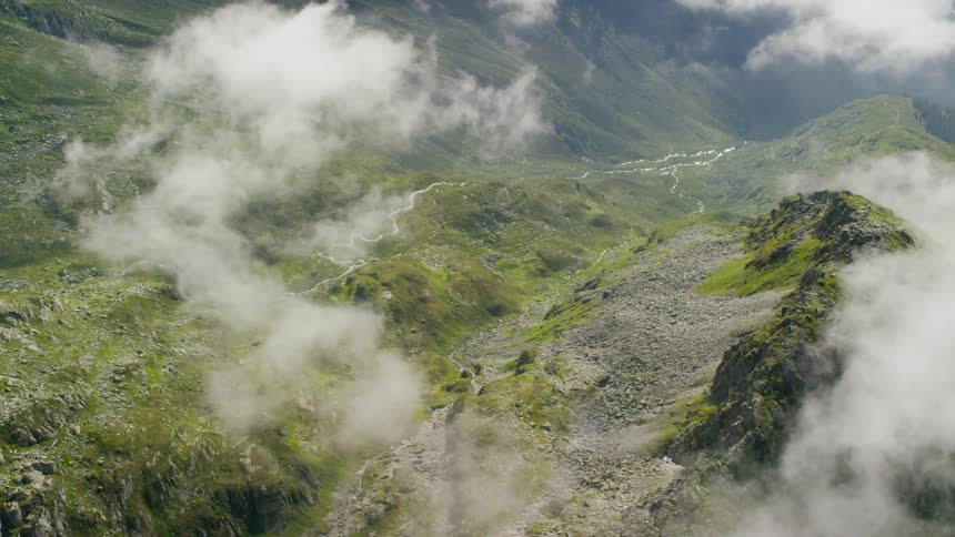 Clouds hover over mountains during the day