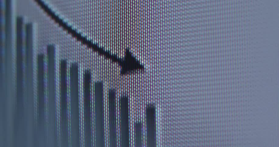 Extreme macro close-up of a computer monitor showing a bar graph with a downward arrow indicating a financial market crash, economic recession, or loss