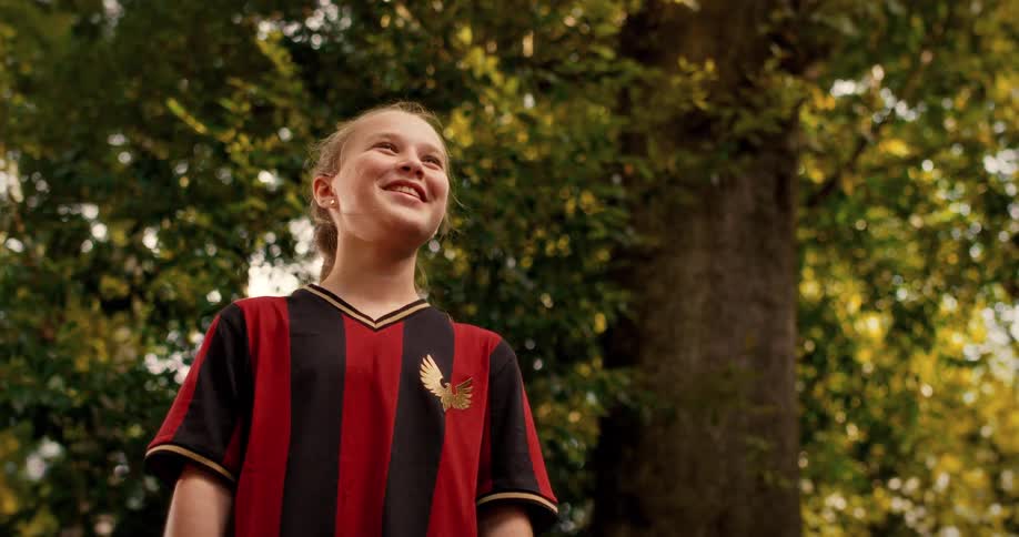 Portrait of a hopeful young female athlete in her soccer uniform smiling confidently outdoors