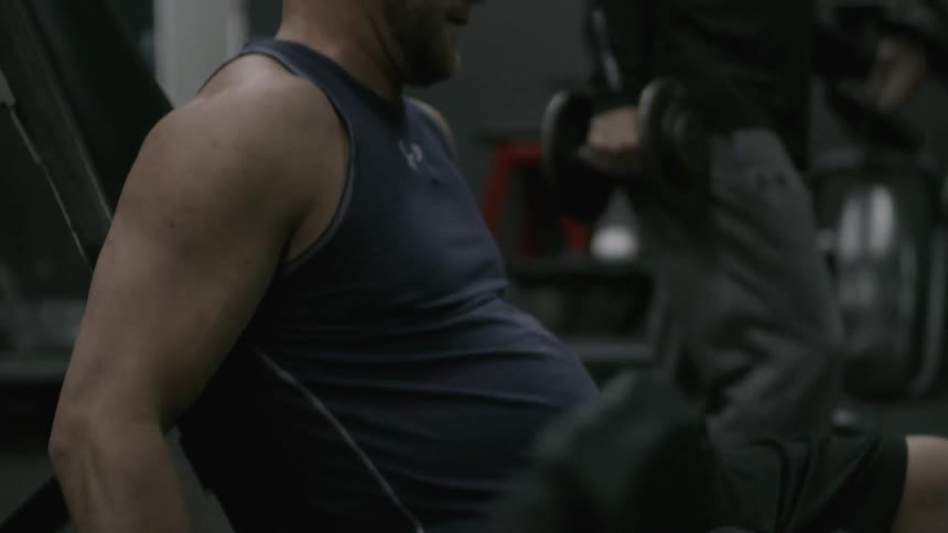 A man curling dumbbells
