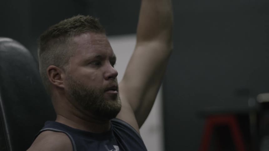 A man is lifting a barbell repeatedly