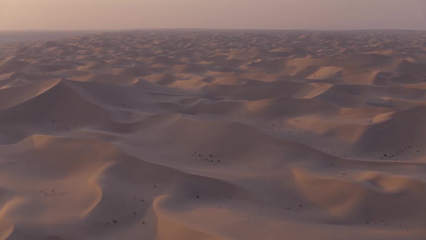 Sunlight shining over vast sand dunes