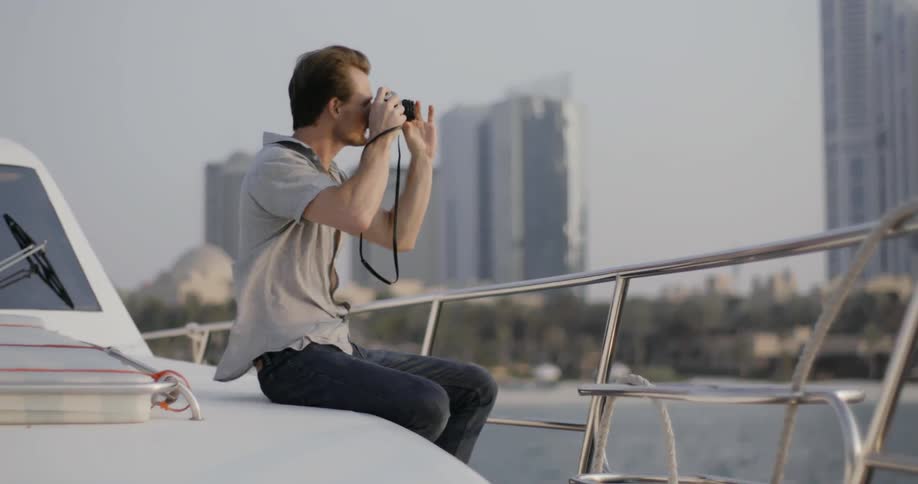 A man takes a picture from a floating boat