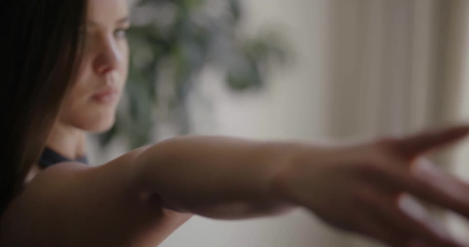 A woman is exercising with her arms raised