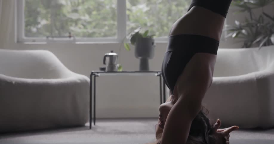 A woman is standing on her head