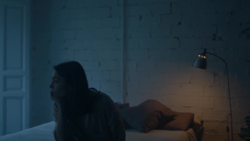 A woman sits in the bed