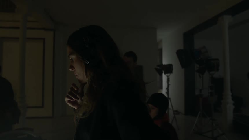 A director and film crew are filming a scene