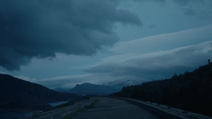 A small road winds around some mountains