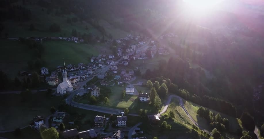 Sunlight shines down on a mountainside town