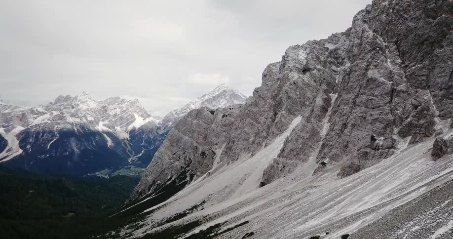 Snow covers a rocky mountainside