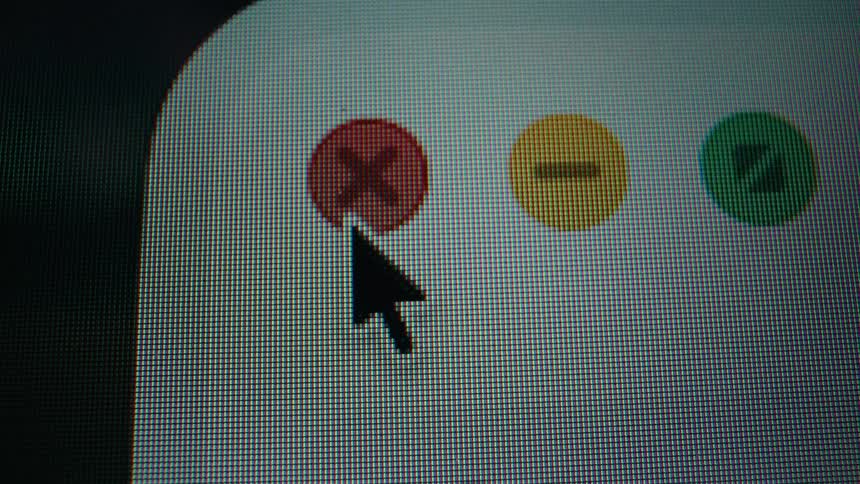 An extreme close-up shot shows a computer cursor clicking the red 'X' to close a window on a pixelated screen