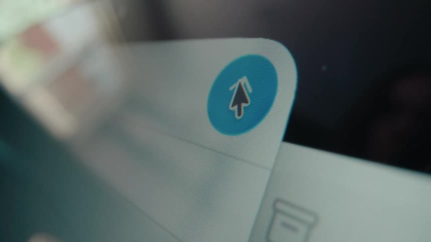 A macro shot shows a cursor clicking the send button on a digital screen to send a message or upload a file