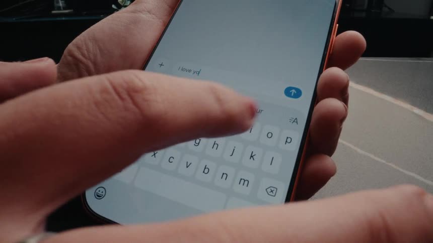 A person types out 'I love you' on their smartphone and sends the heartfelt message to a loved one