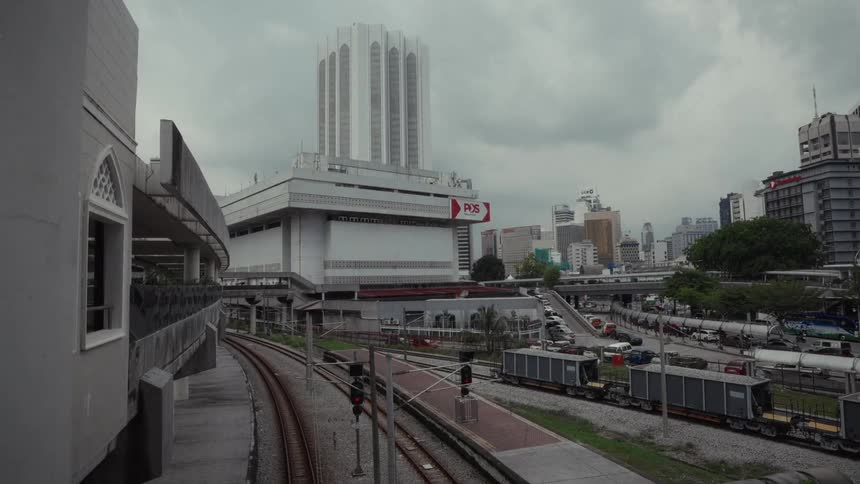 A view of the Dayabumi Complex and surrounding cityscape from a train station in Kuala Lumpur on an overcast day