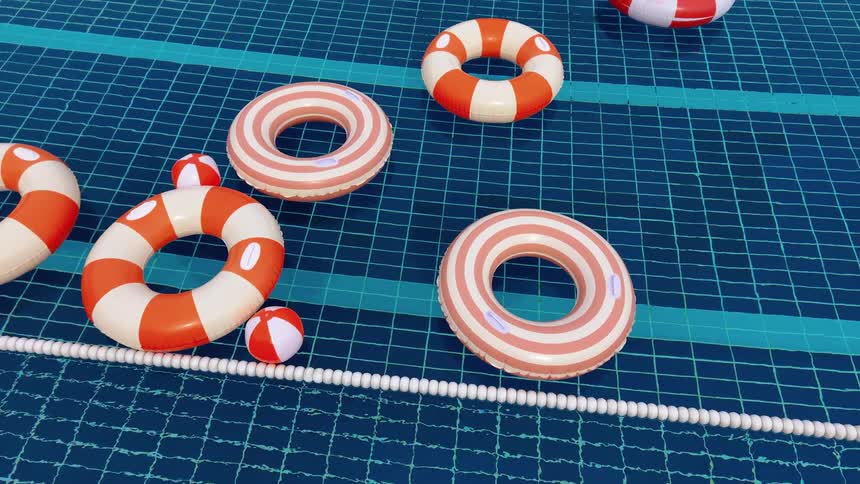 Colorful inflatable rings and balls float idly in a swimming pool covered with a safety net