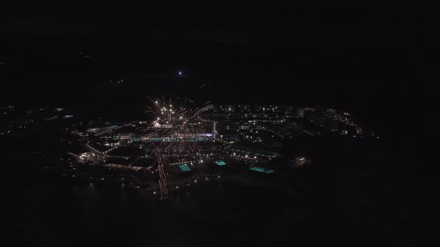 An incredible aerial view captures a spectacular fireworks display illuminating a luxury seaside resort at night