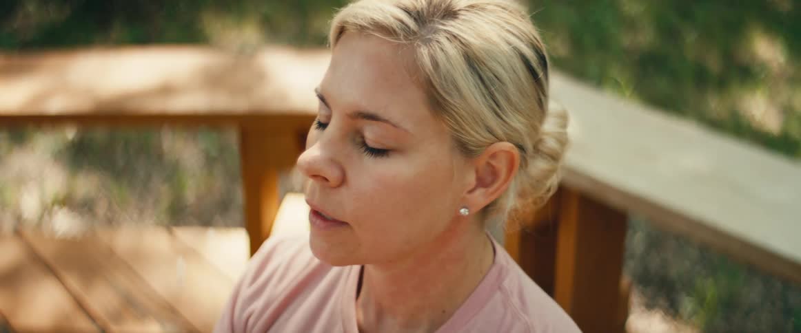 A calm woman finds a moment of peace and mindfulness while meditating outside in nature