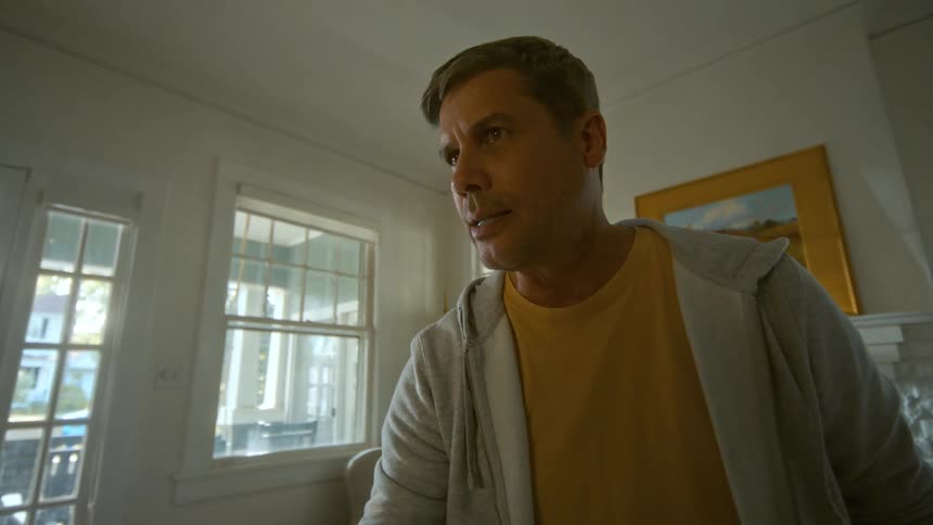 An angry and aggressive man holding a baseball bat threatens someone from a first-person point of view inside a house