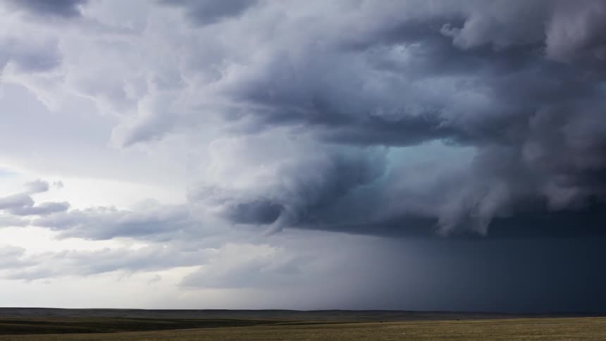 Clouds rolling over plains at sunset