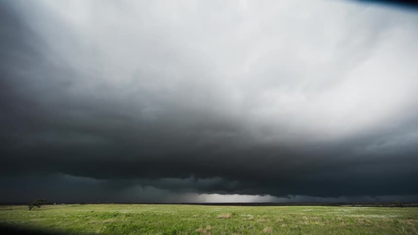 Storm clouds gather over a field