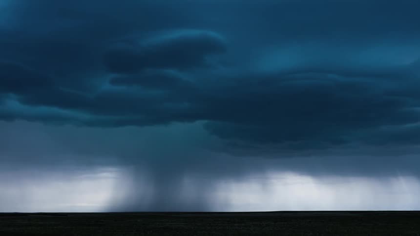 Clouds and lightning move over a plain