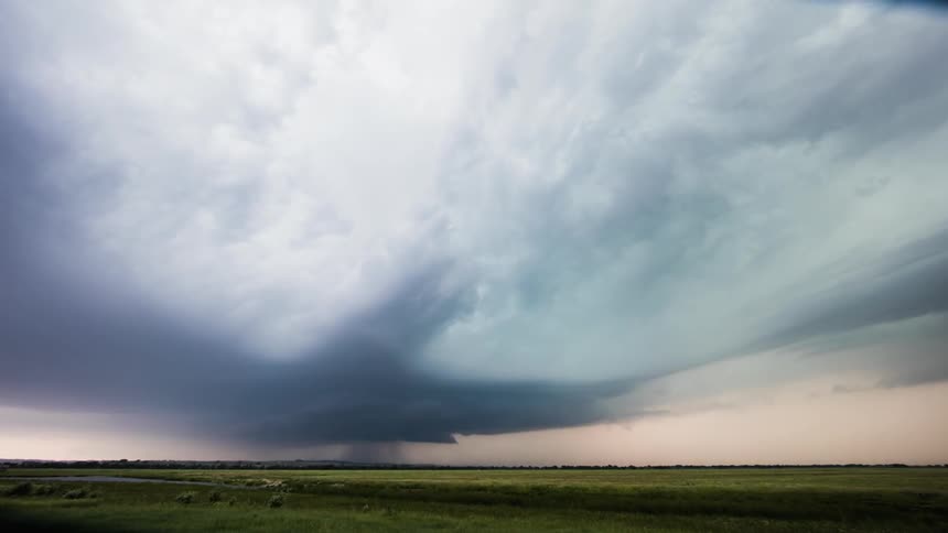 Lightning storm flashes over plains at sunset
