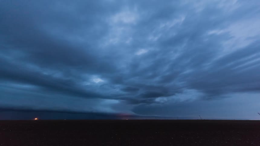 Lightning storm flashes over plains at sunset