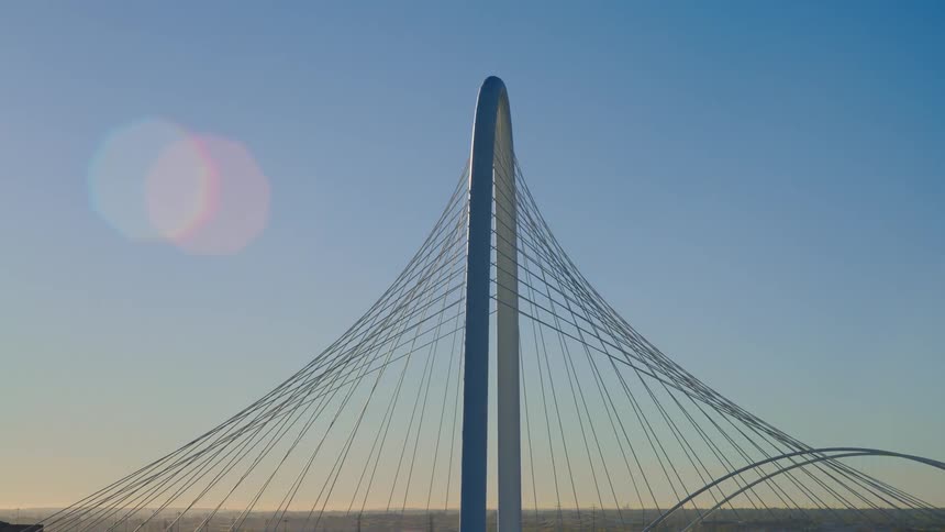 A majestic aerial ascent reveals the architectural beauty of the Margaret Hunt Hill Bridge in Dallas, Texas, during a beautiful sunrise
