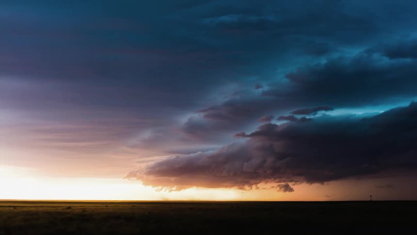 Clouds forming and flowing across sky at sunset