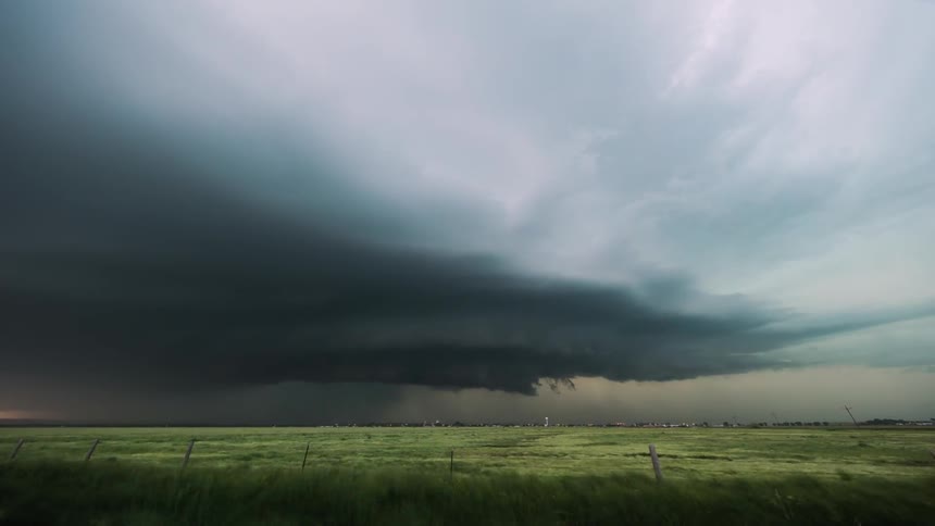 Lightning storm flashes over plains at sunset