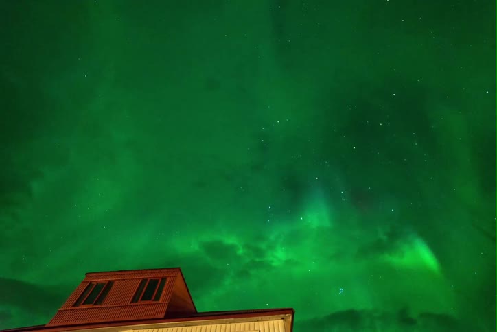 The sky is swirling with green light at night