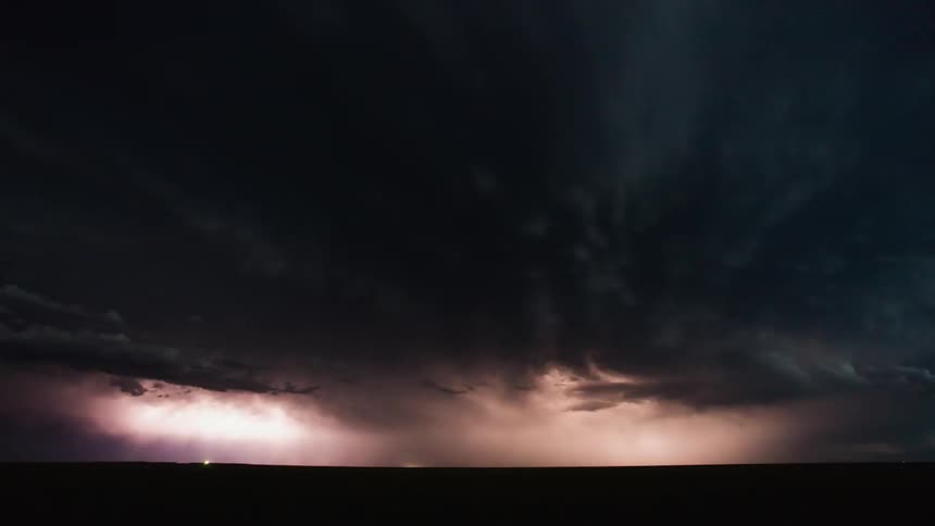 Lightning flashes in the sky across the field