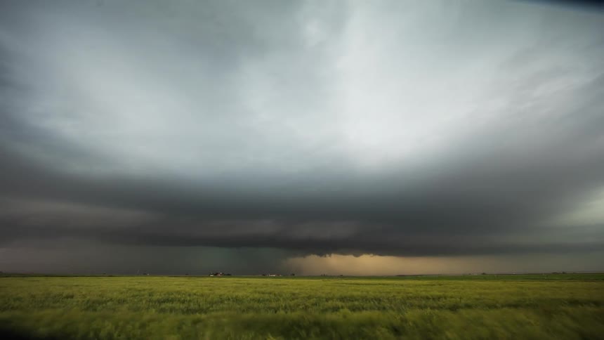 Storm clouds and lighting move over a plain