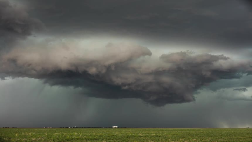 A large storm cloud spins ahead