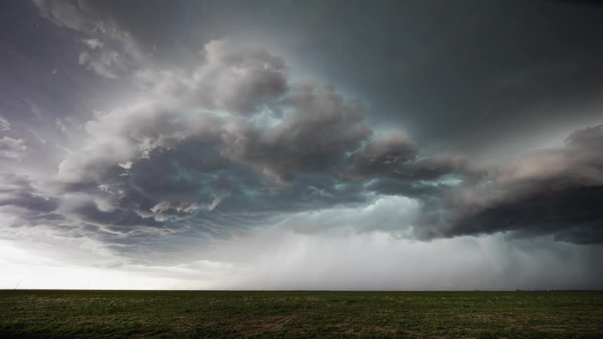 Storm clouds form over an open field