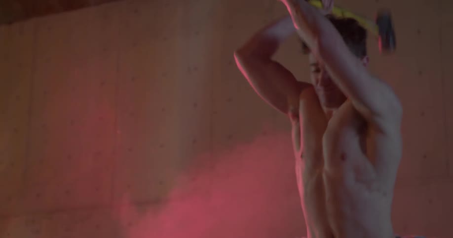 A man is swinging a hammer outside
