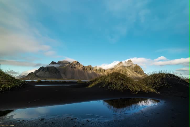 Some water sits before a mountain range