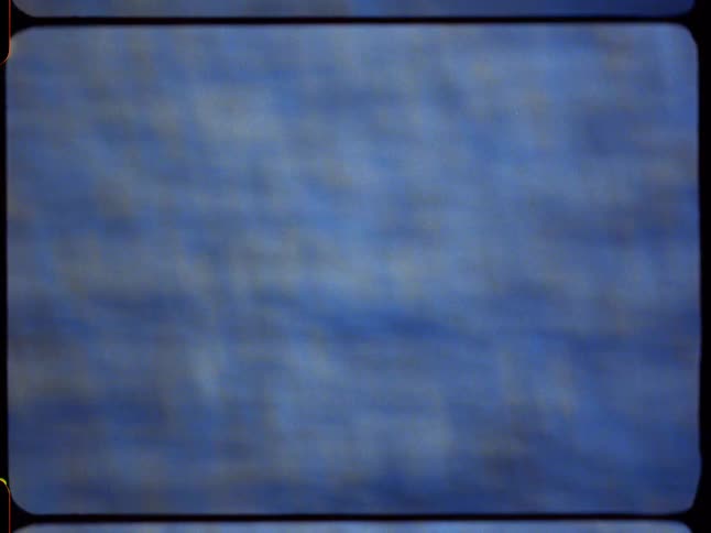 Vintage film captures an abstract, mesmerizing close-up of deep blue water ripples with shimmering reflections