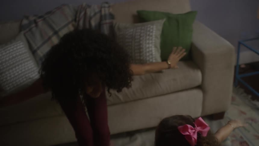 A woman and child dance at home