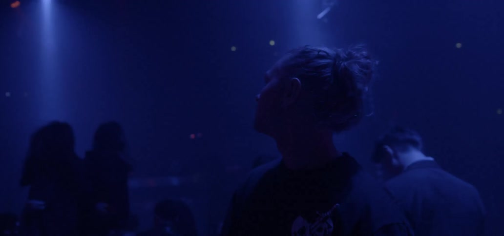 People party in a club with flashing lights