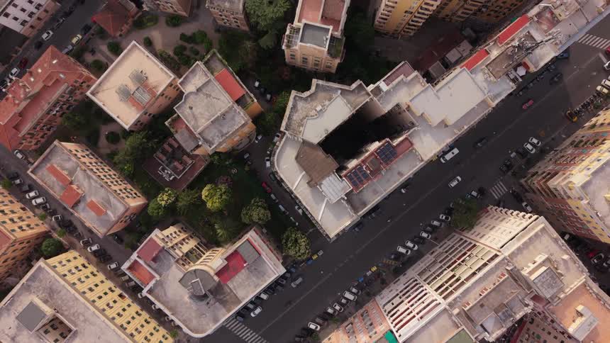 A slow-moving top-down aerial shot reveals the intricate architecture and street layout of a dense European city