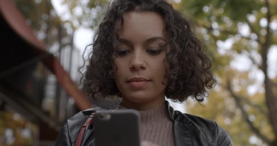 A woman uses her smartphone outside