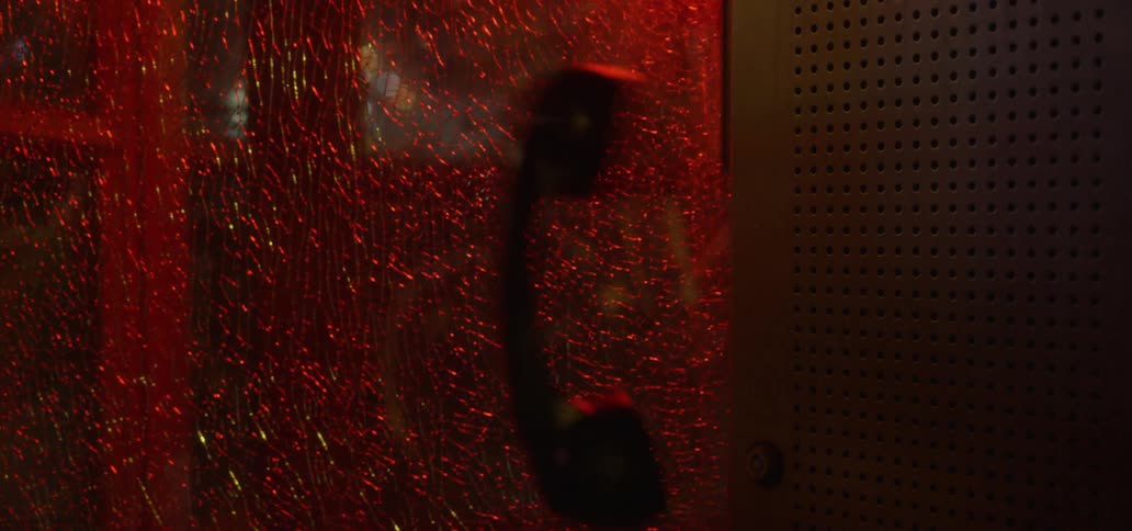 Phone receiver dropping and hanging from a public telephone