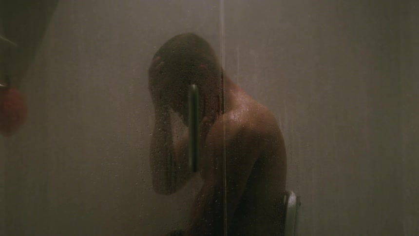 A man is sitting on a chair as he takes a shower