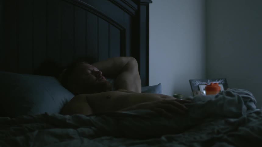 A man is laying in bed